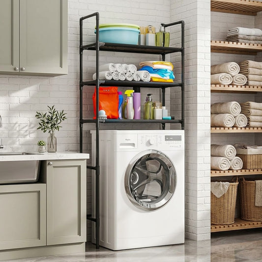 A white front-loading washing machine in a bright laundry room, positioned under a black metal three-tier storage rack filled with towels, detergents, and laundry supplies.