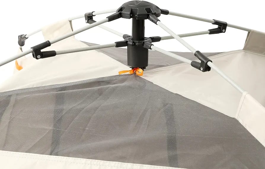 Close-up of a tent canopy with a gray mesh floor, beige fabric walls, and a black central support pole with silver metal arms.