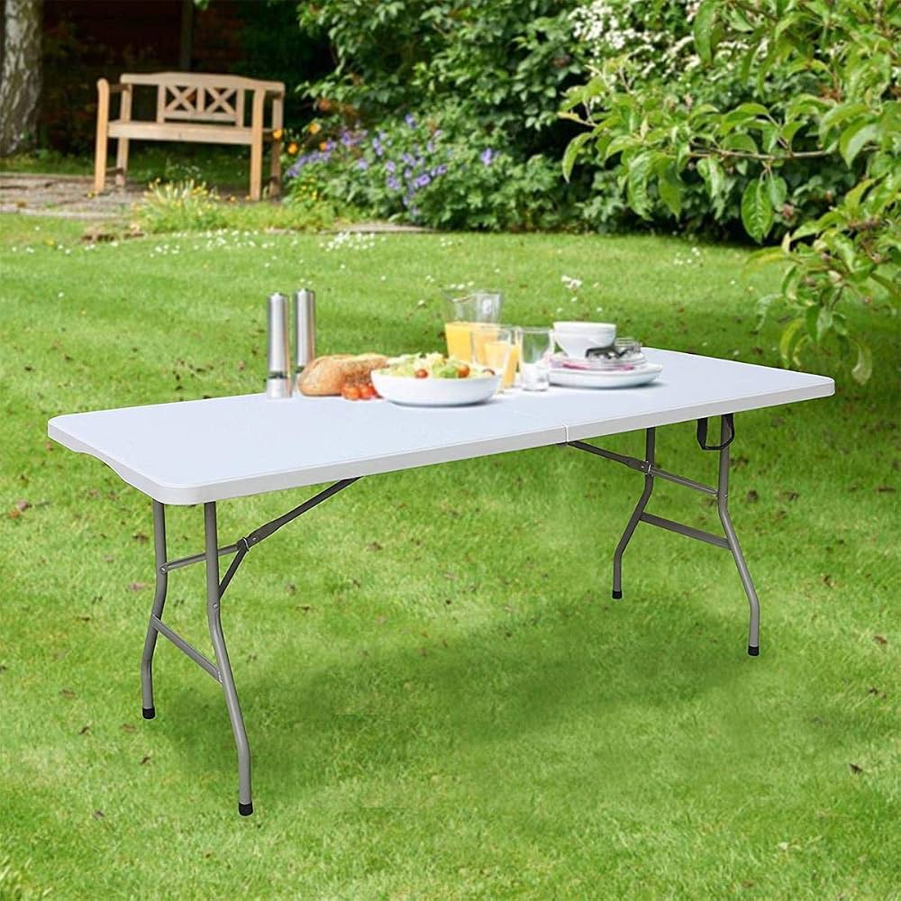 6ft white folding table set up on green garden lawn with food and drinks, outdoor folding table Qatar