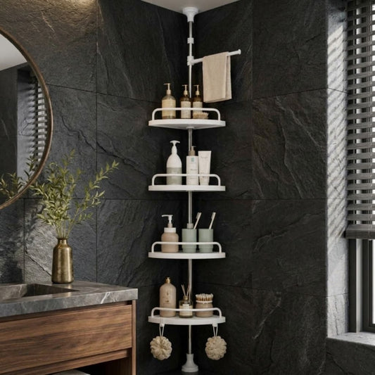 A white metal corner shower shelf set with four tiers and a towel bar, styled with bathroom toiletries in a modern bathroom with dark slate tile walls.