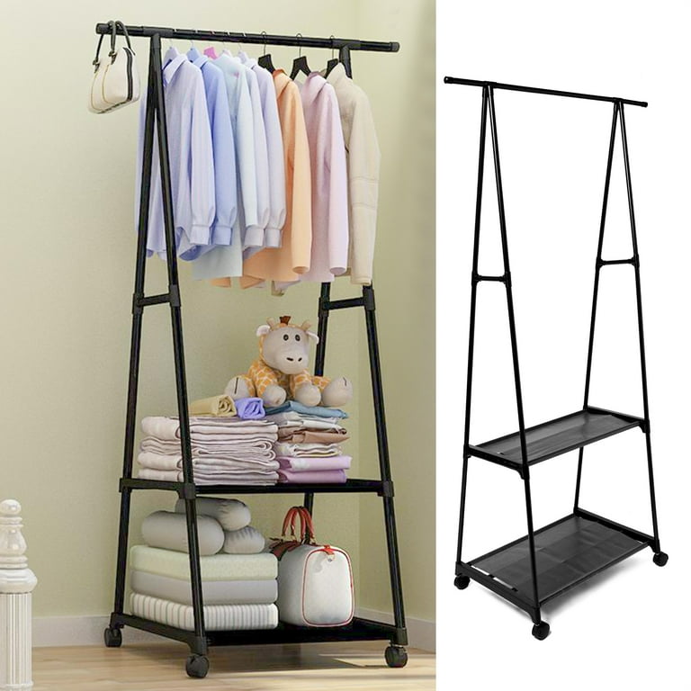 Black garment rack with clothes and folded items on a light green wall background