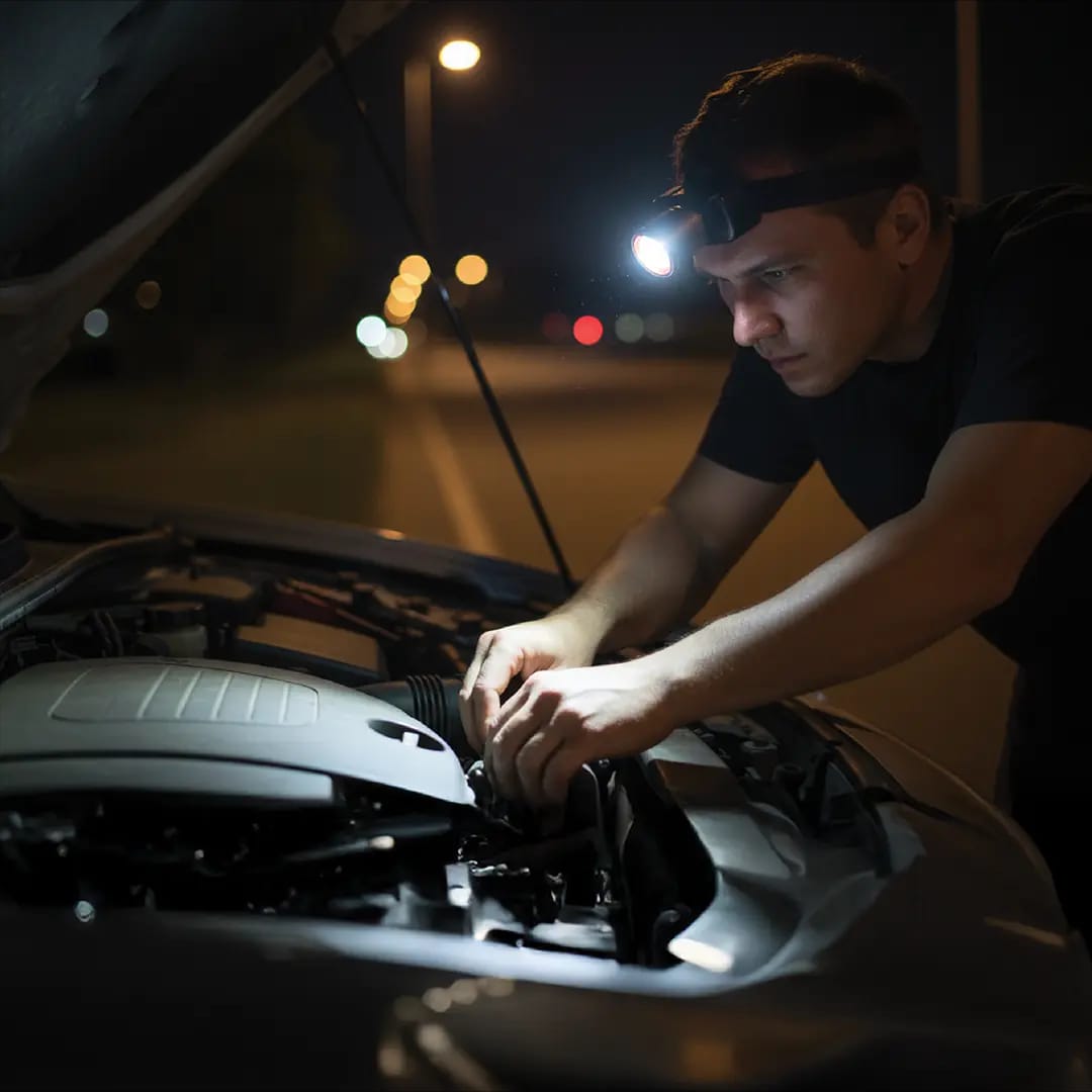 Green Lion rechargeable headlamp used for car repair at night