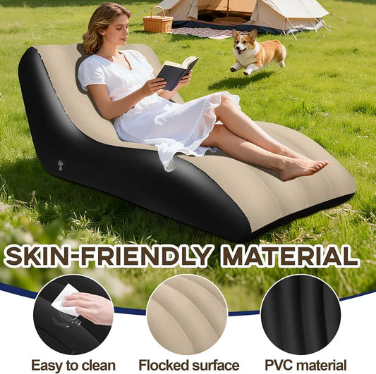 Inflatable outdoor lounge chair in beige and black on grass with woman reading, camping tent in background