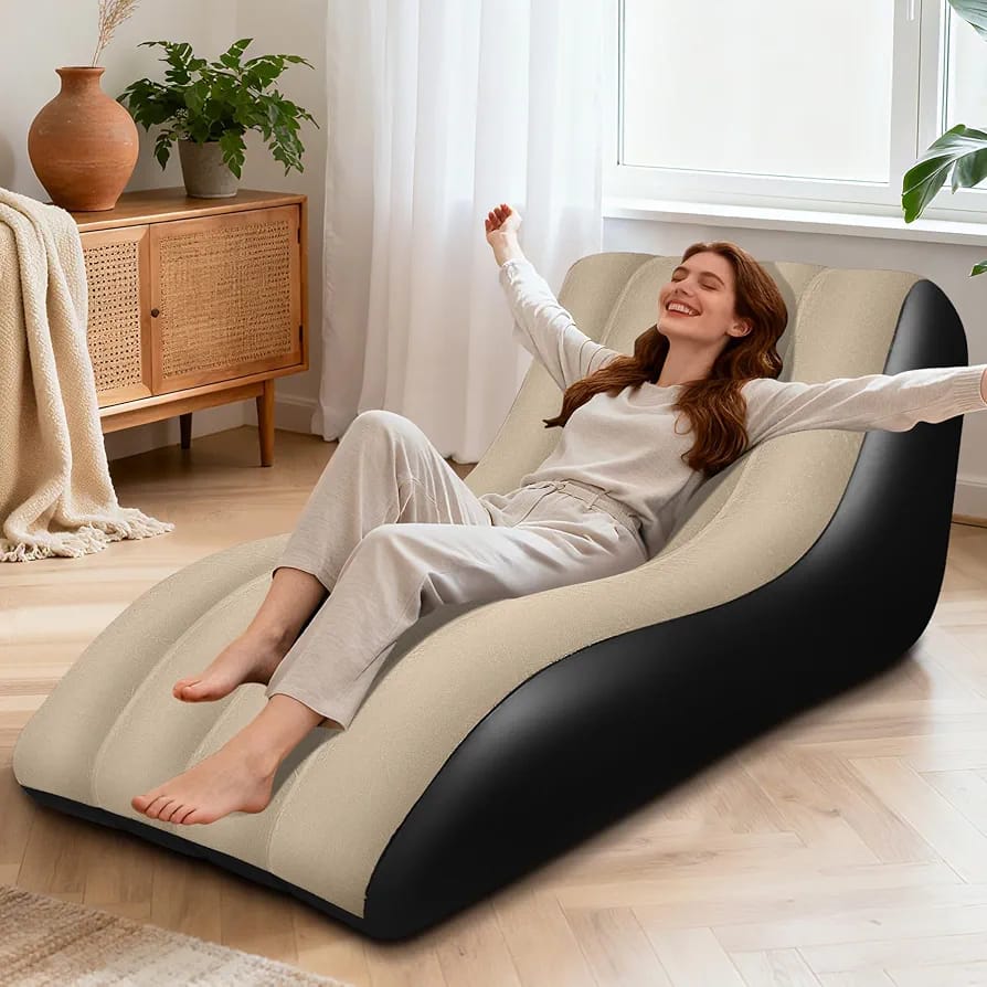 Woman relaxing on black and beige inflatable wave sofa chair in modern living room
