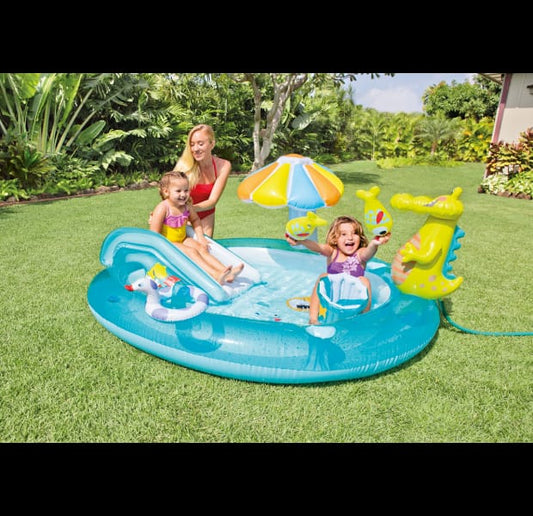 Inflatable pool with children and toys on a grassy lawn