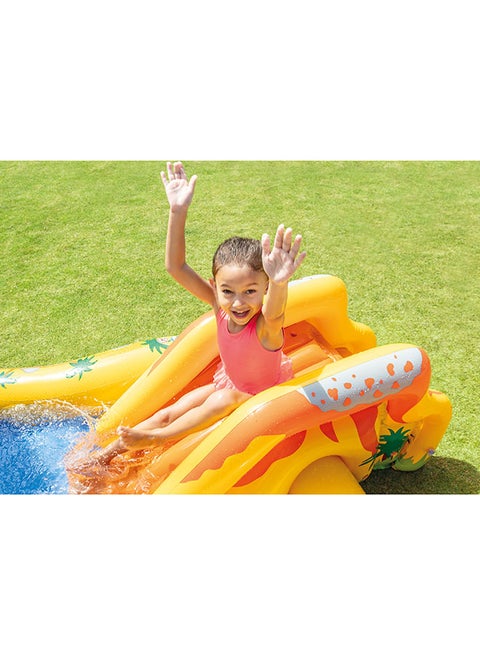 Child on a yellow inflatable slide with a pool, on a grassy background