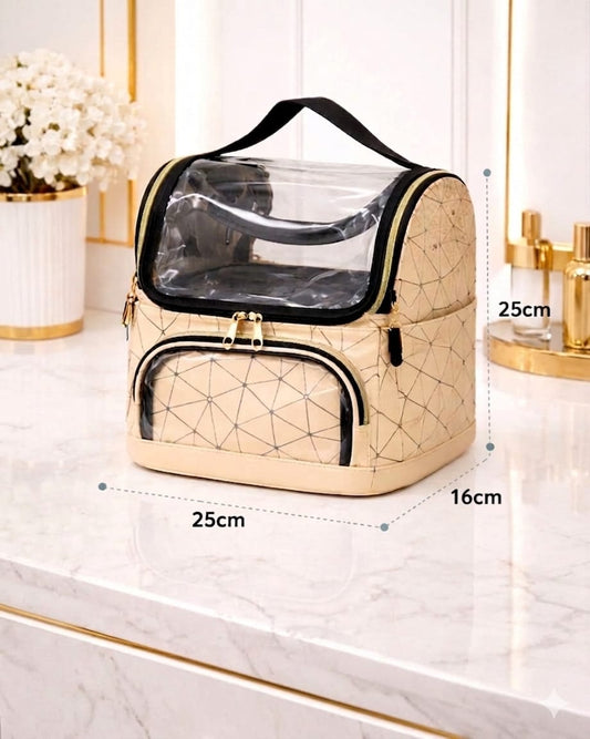 Beige geometric-patterned cosmetic bag with clear top section on a marble surface.