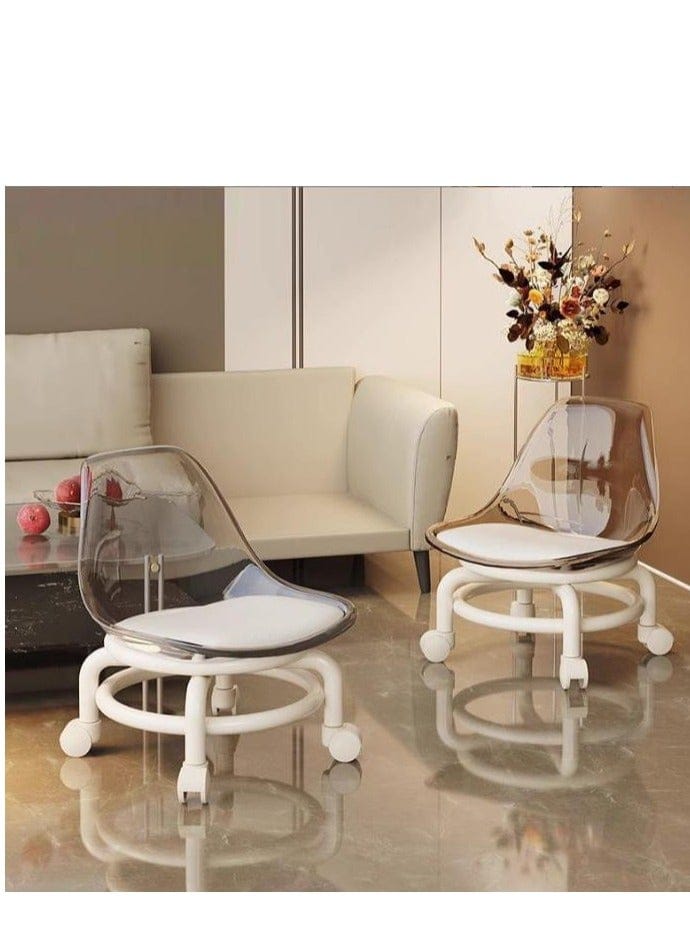 Two modern accent chairs with clear acrylic backs and white bases with casters, shown in a furnished living room setting.