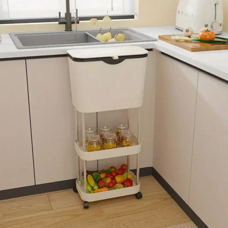 Three-tier rolling cart in a kitchen with fruits and vegetables on the bottom shelf.