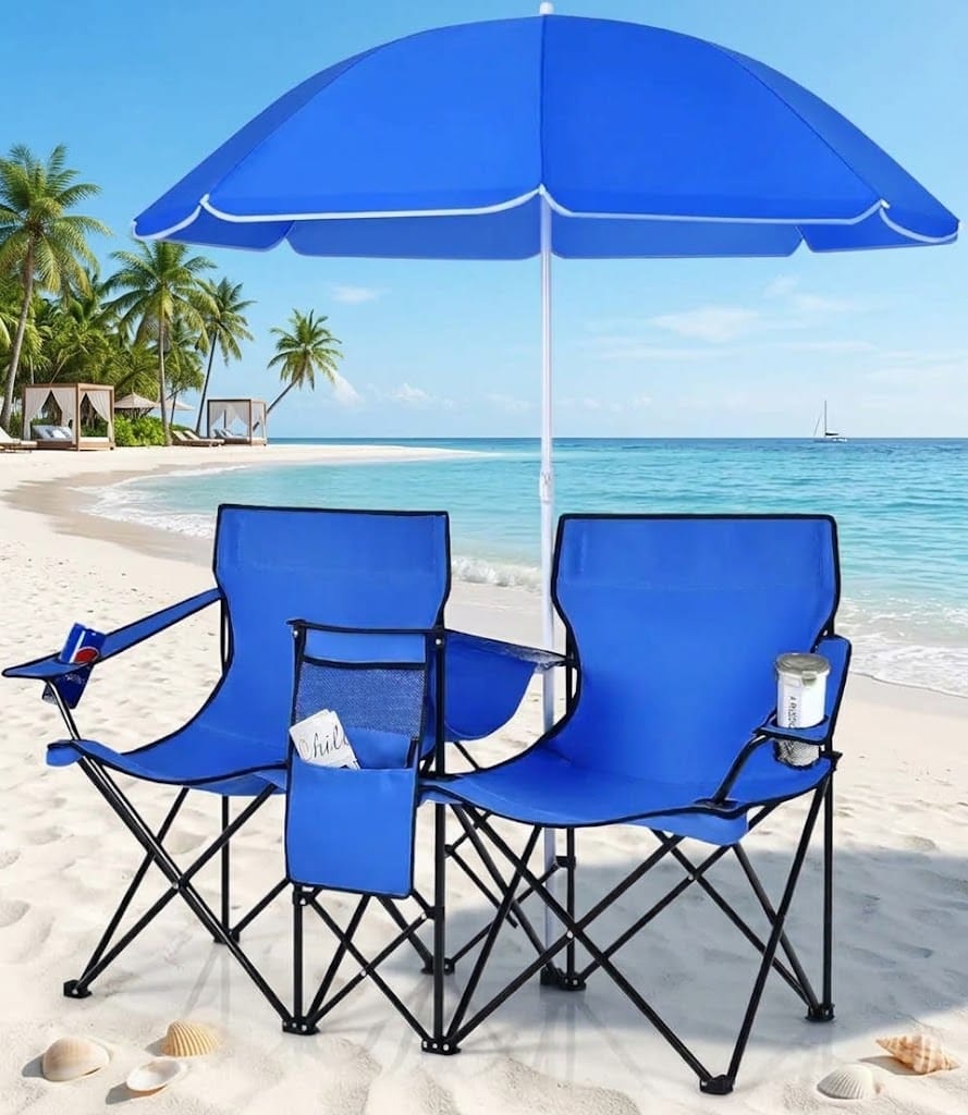 Portable double beach chairs with blue umbrella, cup holders, and folding frame on a sandy beach