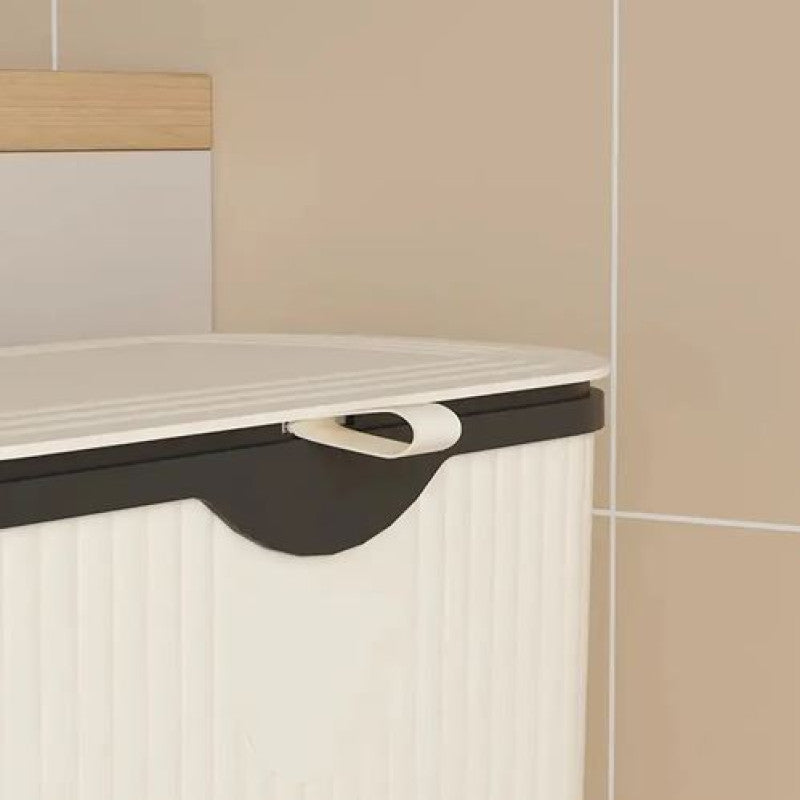 Corner cabinet with a black handle against a beige tiled wall