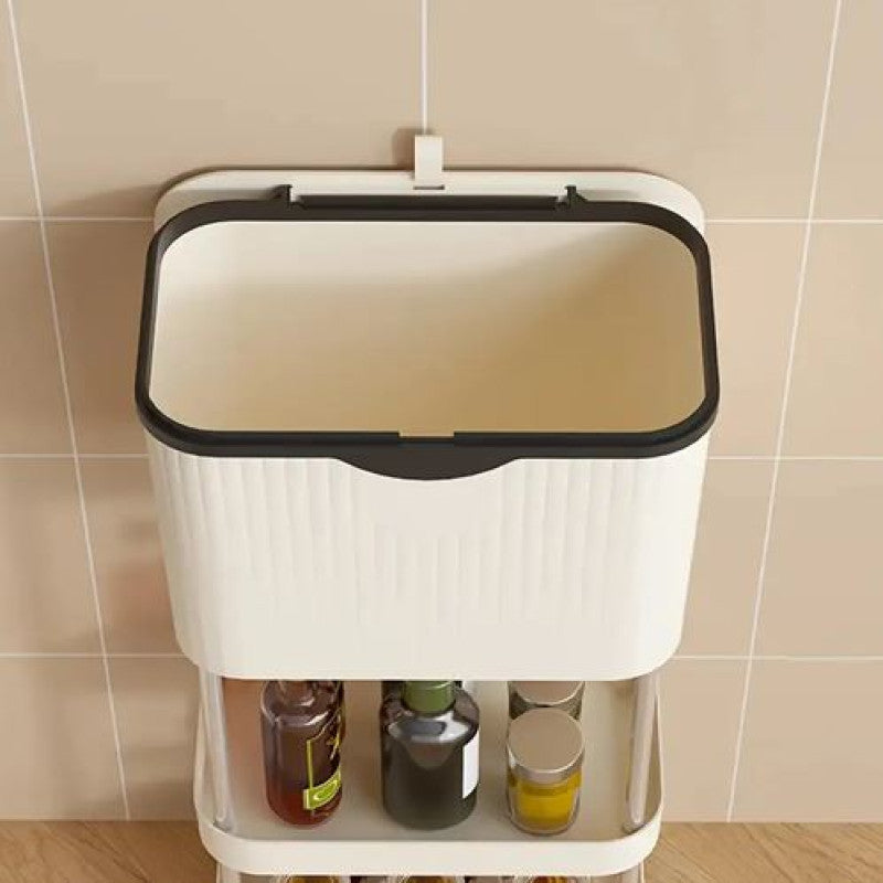 White trash bin with a black lid against a tiled wall.