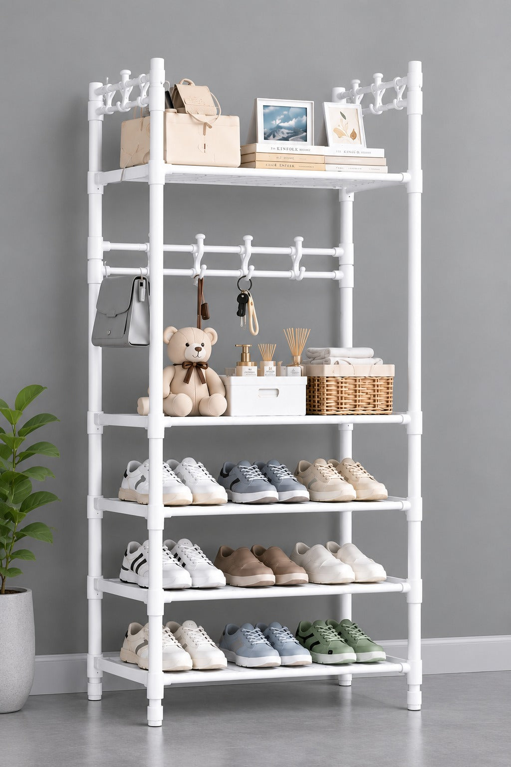 A white plastic multi-tier shoe organizer rack styled with various shoes, a teddy bear, a handbag, and decorative items, set against a plain gray wall.