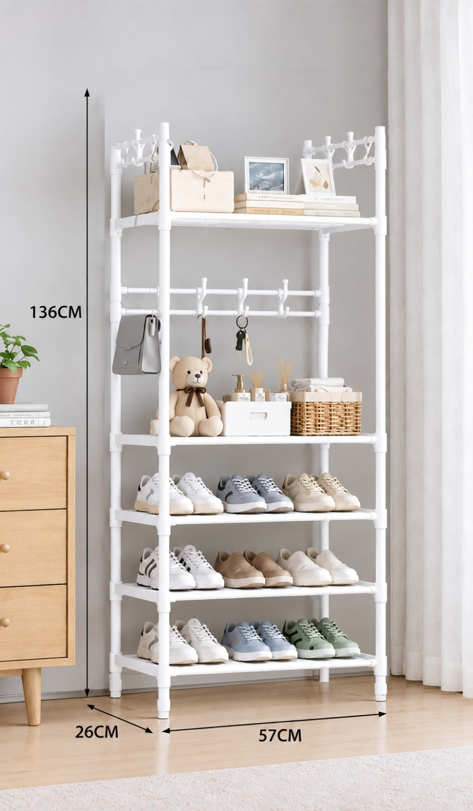 White metal shoe rack organizer with five shelves, hanging hooks, and storage compartments, shown in a room setting with dimension labels indicating 136CM height, 26CM shelf width, and 57CM depth.